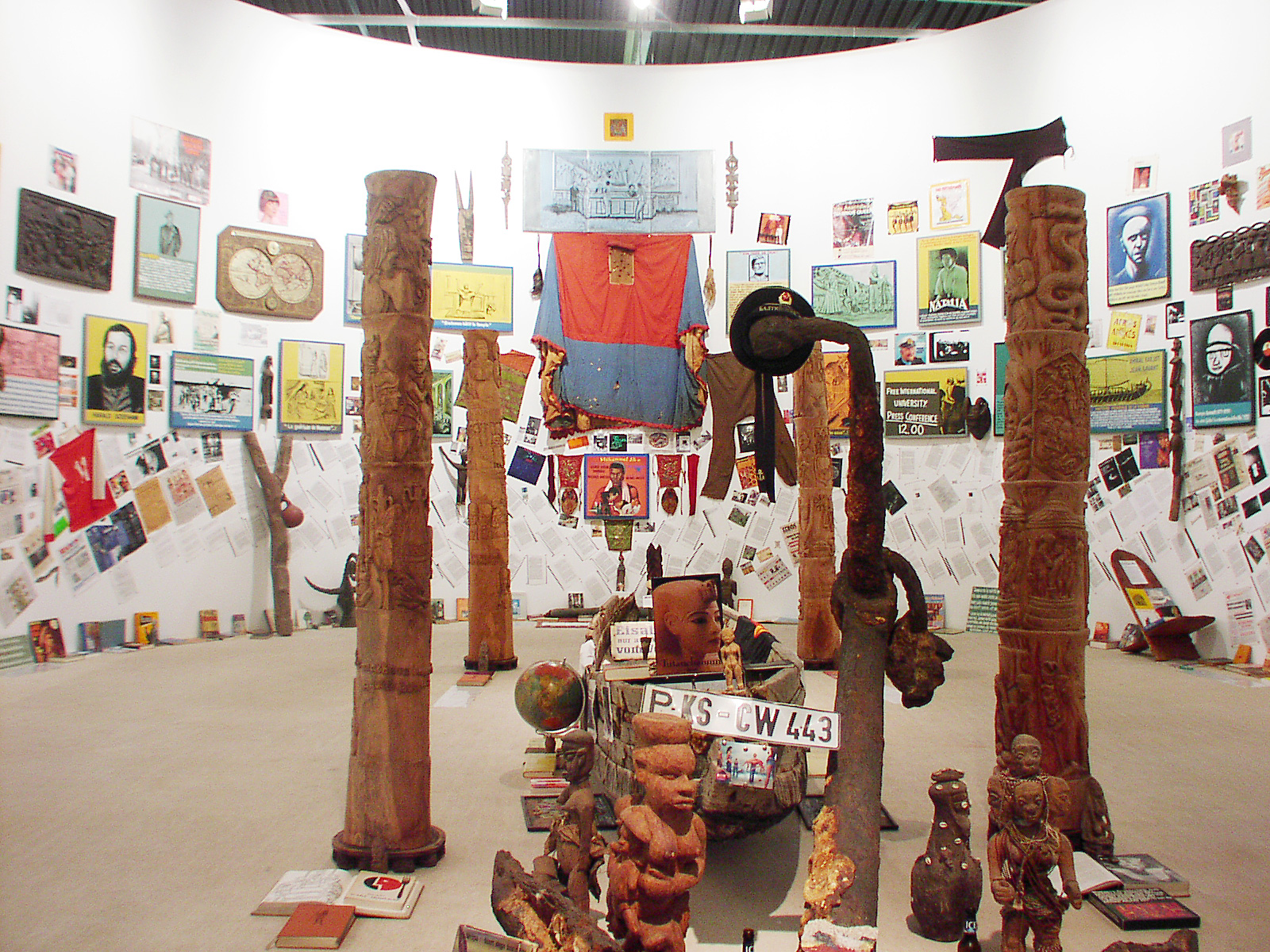 central part of installation with four totem poles and fisher boat