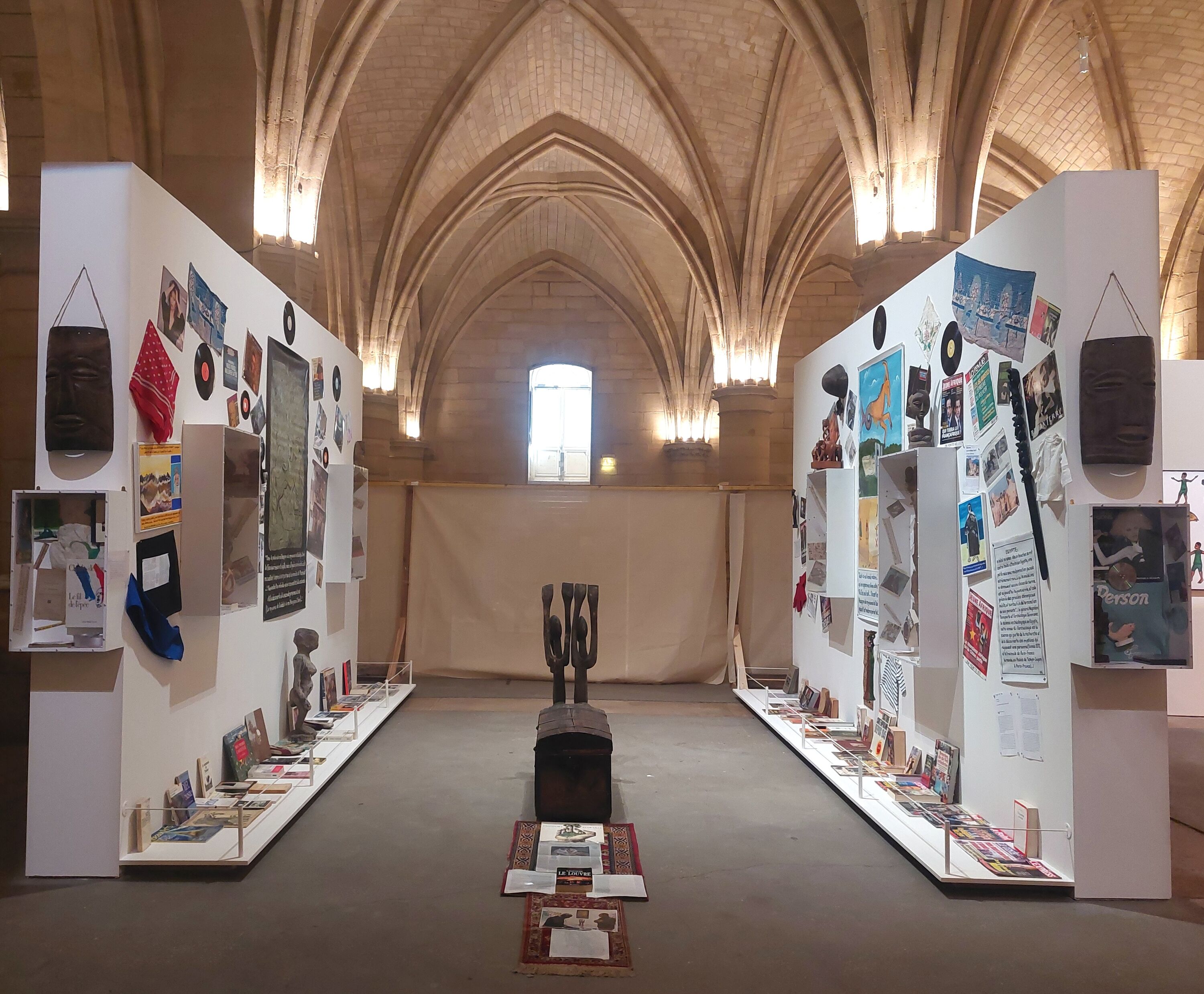 an installation on two walls in a historic space with vaulted ceiling